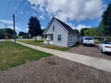 Boyne City house for rent - a blue house with a white truck parked outside