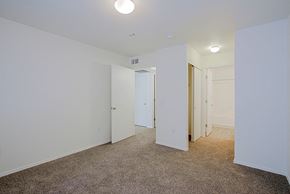 Yuma apartment for rent - a bedroom with white walls and carpet and a door to a closet