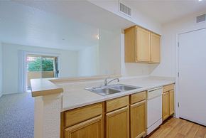 Yuma apartment for rent - a kitchen with a sink and wooden cabinets