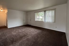 Longview apartment for rent - an empty living room with carpet and a window