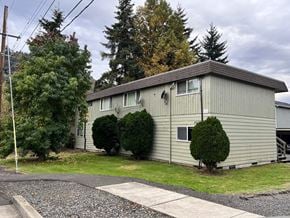 Longview apartment for rent - a white house with green grass and trees