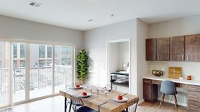 Fargo apartment for rent - a dining room with a table and chairs and a balcony