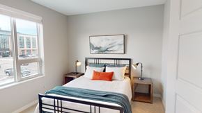 Fargo apartment for rent - a bedroom with a bed and a large window
