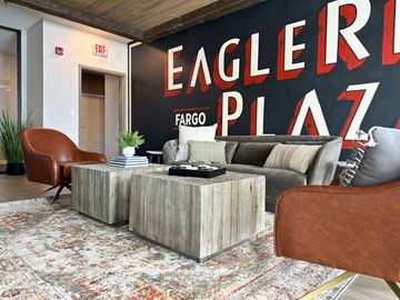 Fargo apartment for rent - a living room with a couch and a coffee table in front of a large mural