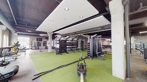Fargo apartment for rent - a gym with weights and exercise equipment on a green carpet