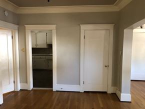 Long Beach apartment for rent - A room with white doors and a wooden floor.
