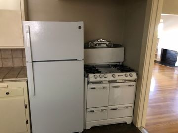 Long Beach apartment for rent - A white refrigerator is in a kitchen next to a white stove.