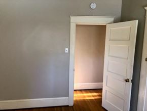 Long Beach apartment for rent - A white door is open to a room with a grey wall.
