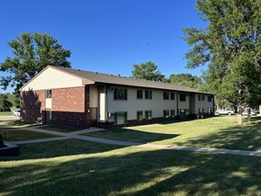 Madison apartment for rent - a white house with a lawn and trees