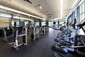 Mclean apartment for rent - a gym with cardio equipment and weights on the floor