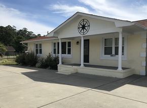 Fayetteville house for rent - the front of a white house with a porch and a window