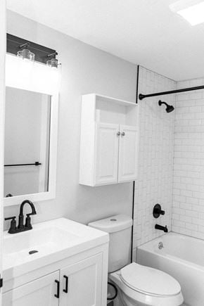 Niagara Falls apartment for rent - a black and white bathroom with a toilet and a sink