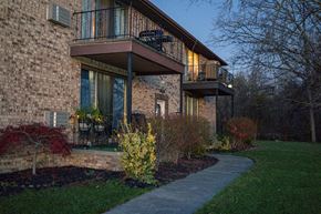 Niagara Falls apartment for rent - the front of a brick house with a walkway and a balcony
