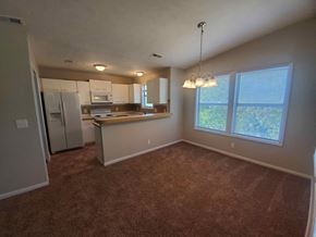 Fayetteville house for rent - an empty living room and kitchen with a large window