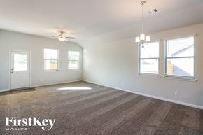 Cleveland house for rent - A room with a carpeted floor and a chandelier hanging from the ceiling.