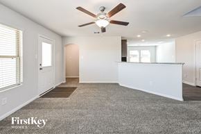 Splendora house for rent - A spacious room with a ceiling fan and a rug on the floor.