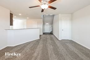 Splendora house for rent - A spacious room with a carpeted floor and a ceiling fan.