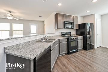 Splendora house for rent - A kitchen with a FirstKey Homes sign on the countertop.