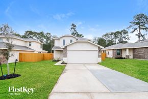 Splendora house for rent - A residential area with houses and a clear sky.