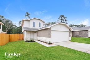 Splendora house for rent - A house with a white exterior and a brown fence is for sale.