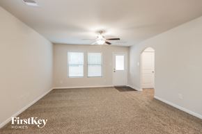 Splendora house for rent - A spacious room with a carpeted floor and a ceiling fan.
