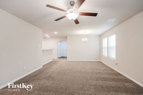 Splendora house for rent - A spacious room with a carpeted floor and a ceiling fan.