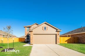 Splendora house for rent - A house with a garage and a driveway in front of it.