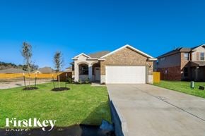 Splendora house for rent - A house with a garage and a driveway is shown in the image.