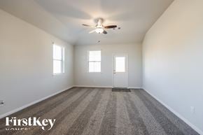 Splendora house for rent - A spacious room with a carpeted floor and a ceiling fan.