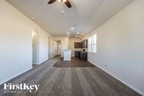 Splendora house for rent - A spacious room with a carpeted floor and a ceiling fan.