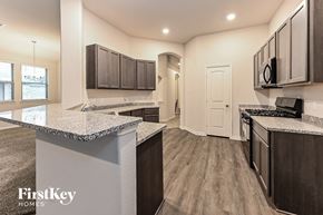 Cleveland house for rent - a kitchen with granite counter tops and dark wood cabinets