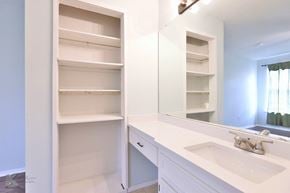 Abilene house for rent - A white bathroom with a sink and a large mirror.