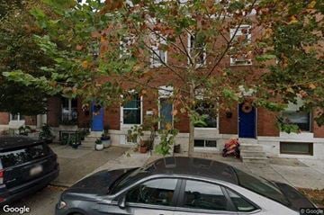Baltimore house for rent - a house with a car parked in front of it