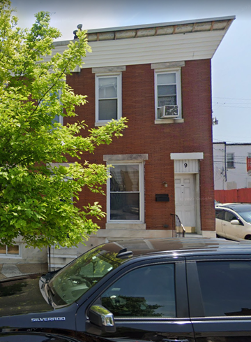 Baltimore house for rent - a building with a car parked in front of it