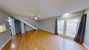 Aurora house for rent - a living room with a hard wood floor and a large window