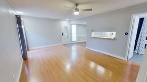 Aurora house for rent - an empty living room with wood floors and a ceiling fan