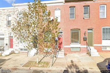 Baltimore house for rent - a red brick building with a tree in front of it