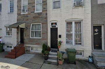 Baltimore house for rent - a white brick house with a black door