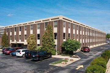 Beachwood apartment for rent - an office building with cars parked in a parking lot