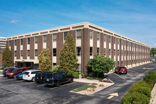 Beachwood apartment for rent - an office building with cars parked in a parking lot