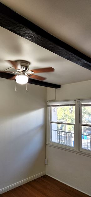 Los Angeles apartment for rent - a bedroom with a ceiling fan and a window