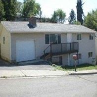 Pullman house for rent - A small house with a garage door and a balcony.