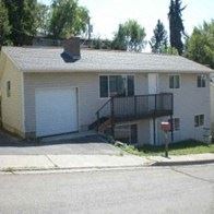 Pullman house for rent - A small house with a garage door and a balcony.
