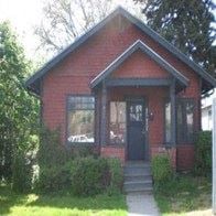 Pullman house for rent - a small red brick house with a black door