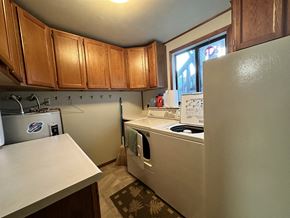 Sitka house for rent - a kitchen with white appliances and wooden cabinets