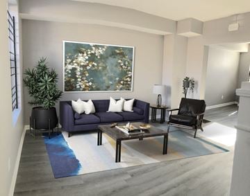 Baltimore house for rent - a living room with a purple couch and a coffee table
