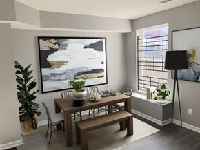 Baltimore house for rent - a dining room with a table and chairs and a painting on the wall