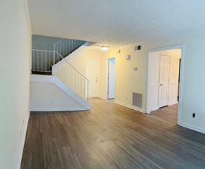 Dunwoody apartment for rent - A room with a staircase and white walls.