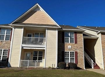 Fayetteville house for rent - A two-story house with a balcony on the first floor.