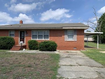 Hope Mills house for rent - a small brick house with a driveway in front of it